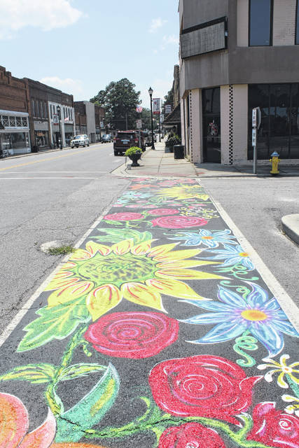 
			
				                                Shawn Hobbs and Cameron Fisher, Small Town Main Street Program volunteers in Roseboro, helped paint some crosswalk stamps.
                                 Brendaly Vega Davis|Sampson Independent

			
		