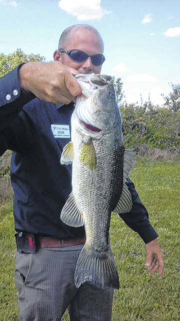 <p>Doug Jones shows a fish he captured. A fundraiser is underway to help his family after Jones passed away suddenly.</p>