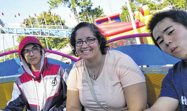 
			
				                                Kai Harada, right, enjoys an amusement park ride with his host family, Darrah-Helena Lobo-Caves and her son, Colin.
                                 Courtesy Photo

			
		