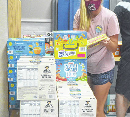  Olivia Gillespie stacks the last of the 11,000 items she collected for her project ‘Insecure No More.’ Michael B. Hardison | Sampson Independent 