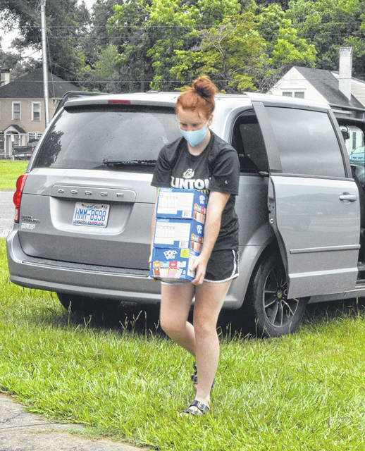 <p>Olivia’s sister Evan Gillespie helps carry in some of the items at Sunset Avenue.</p> <p>Michael B. Hardison | Sampson Independent</p>