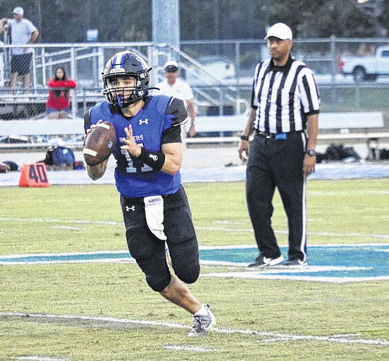 
			
				                                Midway’s Wyatt Holland surveys the field, looking for a receiver to target, during a previous game. Holland finished the game against Richlands going 18-of-24 passing for 295 yards and five touchdowns.
                                 File Photo | Sampson Independent

			
		