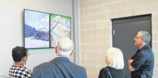 
			
				                                Pictured, from left, are county commissioners Lethia Lee, Allen McLamb and Sue Lee with EMS Director Rick Sauer. The display they’re watching was a slide show of the how the new Emergency Services facility was built.
                                 Michael B. Hardison | Sampson Independent

			
		